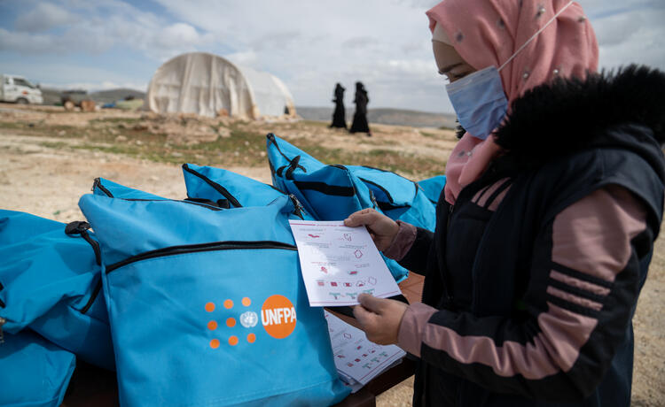 In the Sheikh Bahr camp in the countryside of Idlib,Syria, UNFPA and partners distribute dignity kits including hygiene products for menstruation, soap, detergent and warm clothes. © UNFPA/Karam Al-Masri
