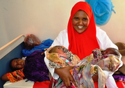 A midwife welcomes twins after a safe delivery at a UNFPA-supported health center in Somalia. 