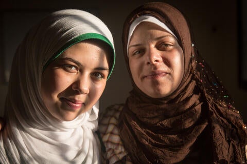 Um Abdo holding her daughter, Raneem, lovingly: I would never allow her to get married young” © UNFPA Lebanon/Sima Diab
