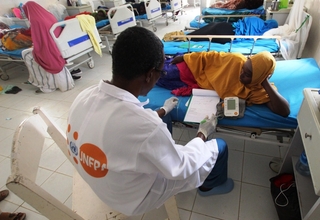 A doctor in Mogadishu, Somalia talks to a fistula patient. 
