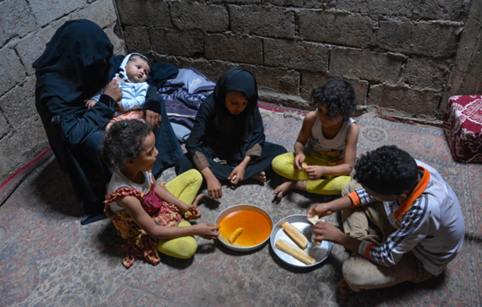 في الصورة: أسرة، تعولها امرأة في تعز، تتناول وجبة الغذاء. © مكتب صندوق الأمم المتحدة للسكان في اليمن