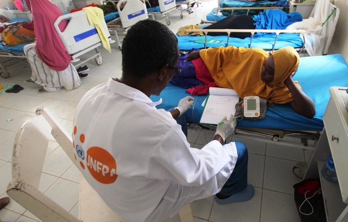 A doctor in Mogadishu, Somalia talks to a fistula patient. 
