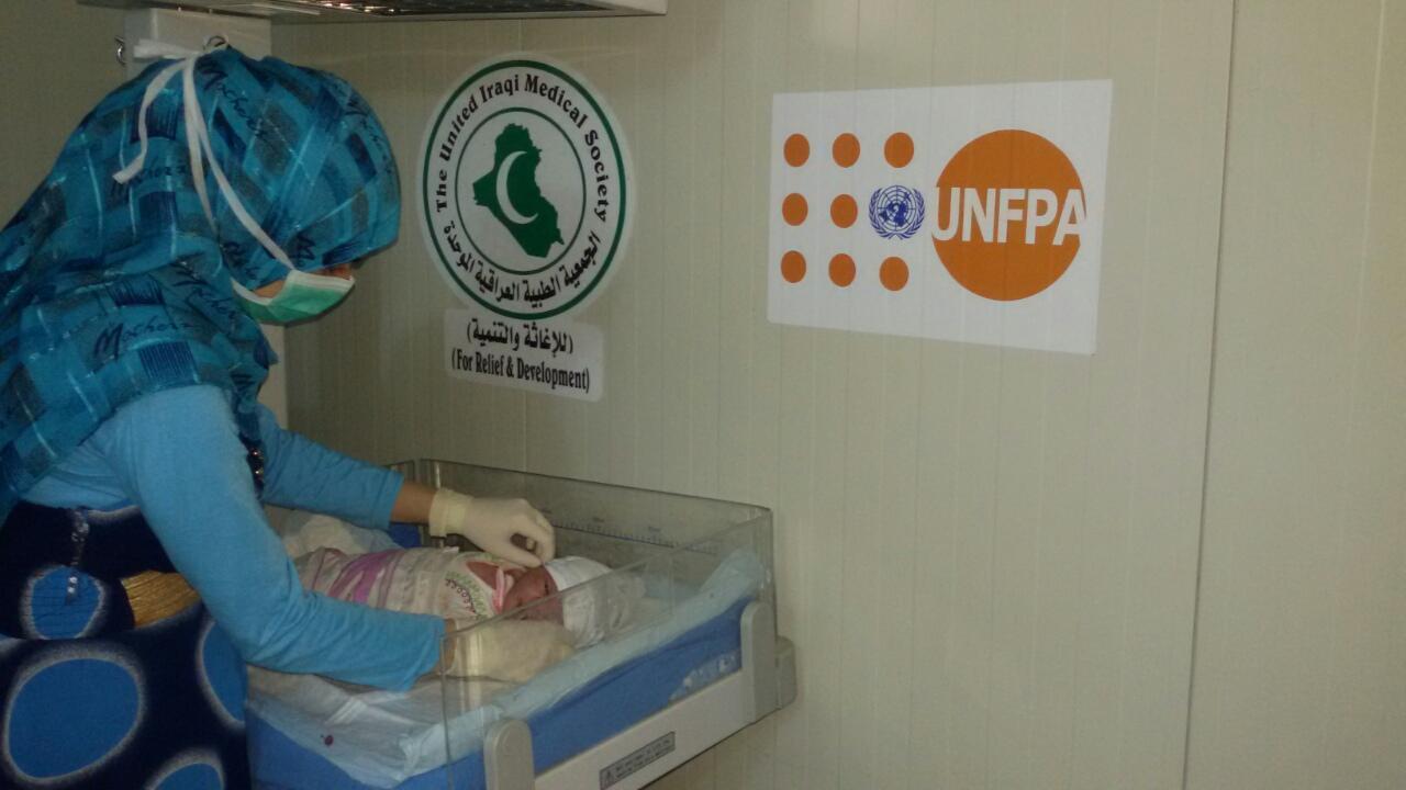 A health provider checking on a newly born baby in Habbaniya delivery room, Anbar governorate, Central Iraq