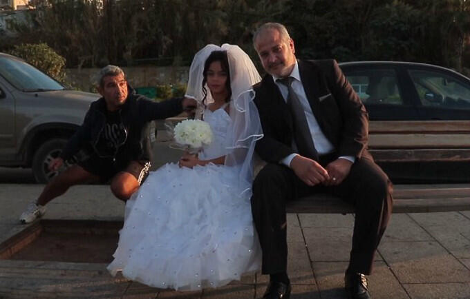 An outraged passer bye tries to get the young bride's attention during a staged photo shoot drawing attention to the issue of child marriage in Lebanon. © KAFA (enough) Violence & Exploitation, Lebanon