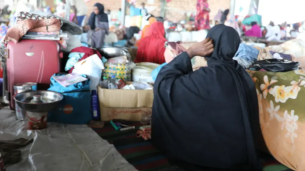 Women and girls who have been displaced from their homes take refuge in a bus shelter. © UNFPA Sudan / Sufian Abdul-Mouty