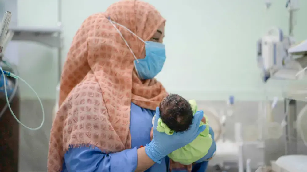 A health worker takes care of newborn babies in the UNFPA-supported neonatal department of the Al Shaab Hospital in Aden, Yemen.